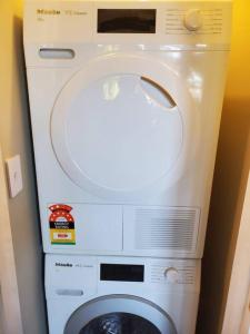 a washer and dryer in a room at Koru Flat in Dunedin