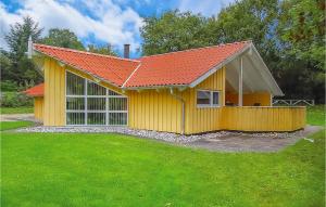 a small yellow house with an orange roof at Awesome Home In Hejls With 4 Bedrooms, Sauna And Wifi in Hejls
