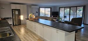 a kitchen with a counter top and a living room at Serendipity On Barrington in Barrington