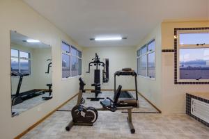 a fitness room with tread machines and a fireplace at Bristol Centro Civico Curitiba in Curitiba