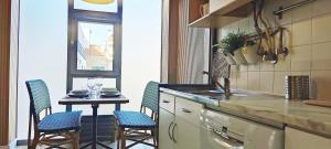 a kitchen with a table with chairs and a counter top at Porto Terrace in Espinho