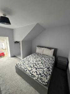 a bedroom with a bed with a white bedspread at Boyds Entry flat Old town in Edinburgh