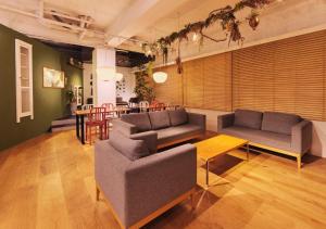 a living room with two couches and a table at Hotel Graphy Nezu in Tokyo