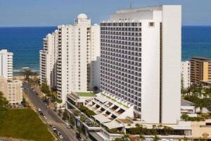a large white building in front of the ocean at Sea Views, 150 mtrs to Surfers Beach, Ideal Location for Surfers Paradise in Gold Coast