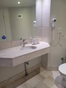 a bathroom with a sink and a toilet at Sea Views, 150 mtrs to Surfers Beach, Ideal Location for Surfers Paradise in Gold Coast