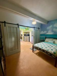 a bedroom with a bed and an open door at Zen Cove w/rental vehicle access in Gros Islet