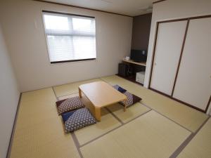 Postel nebo postele na pokoji v ubytování Misato Town Community Lodge Wakuasu