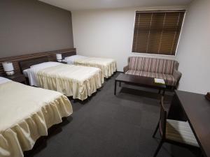 Postel nebo postele na pokoji v ubytování Misato Town Community Lodge Wakuasu