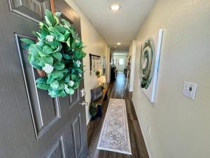 a hallway with a door with a wreath on it at Superb Home 7 minutes from Lackland Air Force Base in San Antonio