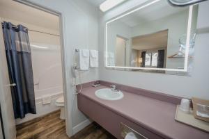 a bathroom with a sink and a mirror at RIVER OAK INN in Bandera