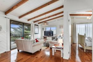 a living room with two couches and a tv at LONGUSTINE - Pet Friendly in Robe
