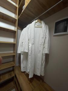 a white shirt is hanging on a closet at Рио in Kirovo