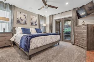 a bedroom with a bed and a flat screen tv at Vi Cottage in North Saanich