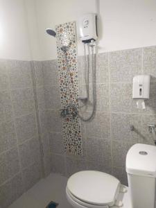 a shower in a bathroom with a toilet at DESTINY's PLACE HOTEL CHEAPEST! COLDEST! MAGANDA! MALINIS! NEAR ROBINSONS XENTRO MALL in Calapan