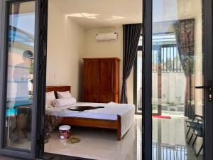 Postel nebo postele na pokoji v ubytování Happy House An Thới PQ