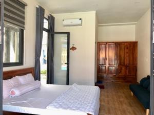 Postel nebo postele na pokoji v ubytování Happy House An Thới PQ