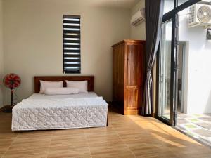 Postel nebo postele na pokoji v ubytování Happy House An Thới PQ