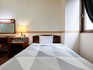 Rúm í herbergi á ecoHotel