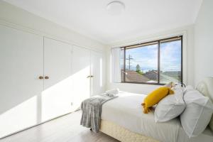 a white bedroom with a bed and a window at Modern and Spacious 5-Bedroom House in Liverpool in Liverpool