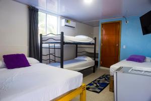 a dorm room with two bunk beds and a window at Posada Bella Vista Bush Bottom in Providencia
