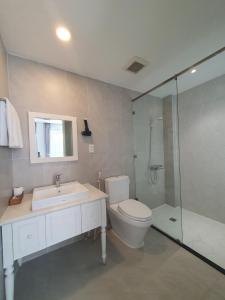 a bathroom with a toilet and a sink and a shower at Thinh Vuong Apartment IX in Ho Chi Minh City