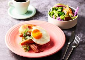 a plate of food with an egg and a salad at HOTEL GRAPHY Shibuya in Tokyo