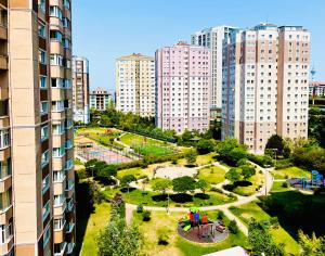 a park in the middle of a city with tall buildings at Beautiful Apartment for rent in Beylikduzu