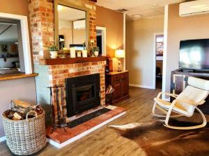 a living room with a fireplace and a television at Allview Escape Blackheath in Blackheath