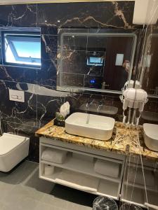 a bathroom with a sink and a mirror at Royal Dương Nội Hotel in Hanoi