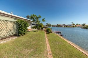 a house next to a body of water at 114 Elizabeth Pde in Forster