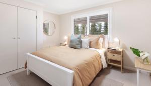 a white bedroom with a bed with pillows and a window at Weetaliba - Country Retreat in Yatte Yattah +31 photos