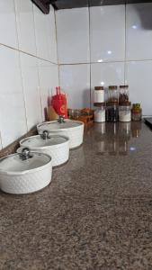 a group of four sinks in a room at Kinyanjui's Homes 001 with WiFi in Morogoro