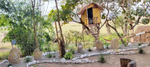 a tree house in the middle of a forest at Pemsee's Tree Town in Sauraha