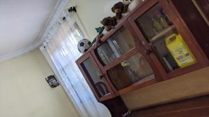 een houten kast met een deur in een kamer bij Kinyanjui's Homes 001 with WiFi in Morogoro
