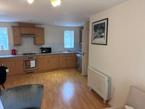 a kitchen with wooden cabinets and a counter top at Kazo in Purfleet