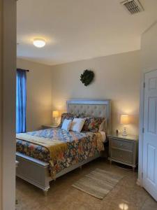 a bedroom with a bed with two night stands and two lamps at Adventures With A Mouse - moments to Disney! in Kissimmee