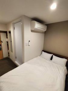 Ліжко або ліжка в номері FLYCAT INN 伊勢