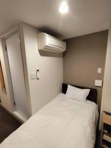 Ліжко або ліжка в номері FLYCAT INN 伊勢