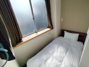 Ліжко або ліжка в номері FLYCAT INN 伊勢