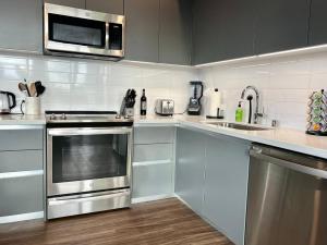 a kitchen with stainless steel appliances and a microwave at Large Hollywood Corner 2 Bedroom with Private Balcony in Los Angeles