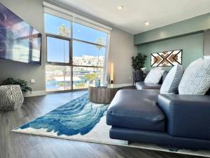 a living room with a couch and a large window at Large Hollywood Corner 2 Bedroom with Private Balcony in Los Angeles