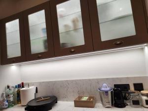 a kitchen with wooden cabinets and a counter top at Villa del Sol in Pesádha