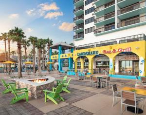 a patio with tables and chairs in front of a building at Margaritaville Beach Resort South Padre Island in South Padre Island