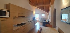 a kitchen with wooden cabinets and a stove top oven at Appartamento da Meto in San Martino di Castrozza