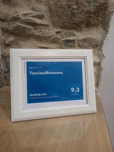 a picture frame on a table in front of a stone wall at TraviesaBetanzos in Betanzos