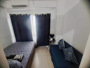 Ένα ή περισσότερα κρεβάτια σε δωμάτιο στο SMDC Wind -Cool Suites Tagaytay +18 φωτογραφίες