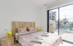 a bedroom with a large bed and a large window at 2 Bedroom Amazing Apartment In Orihuela in Orihuela