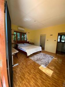 een grote slaapkamer met een bed en een televisie bij Bungalow in the jungle in Salad Beach