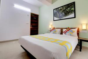 sypialnia z dużym łóżkiem i telewizorem na ścianie w obiekcie OYO Home Exotic Stay Bsk 3rd Stage w mieście Bengaluru