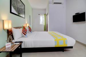 a bedroom with a large bed and a table at OYO Home Exotic Stay Bsk 3rd Stage in Bangalore
